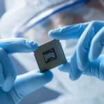 A person holding a semiconductor