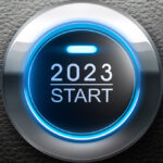 A vehicle's keyless start button that says 2023 Start